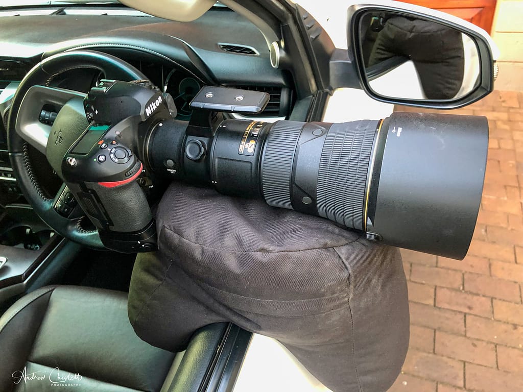 large bean bag on vehicle with camera and lens